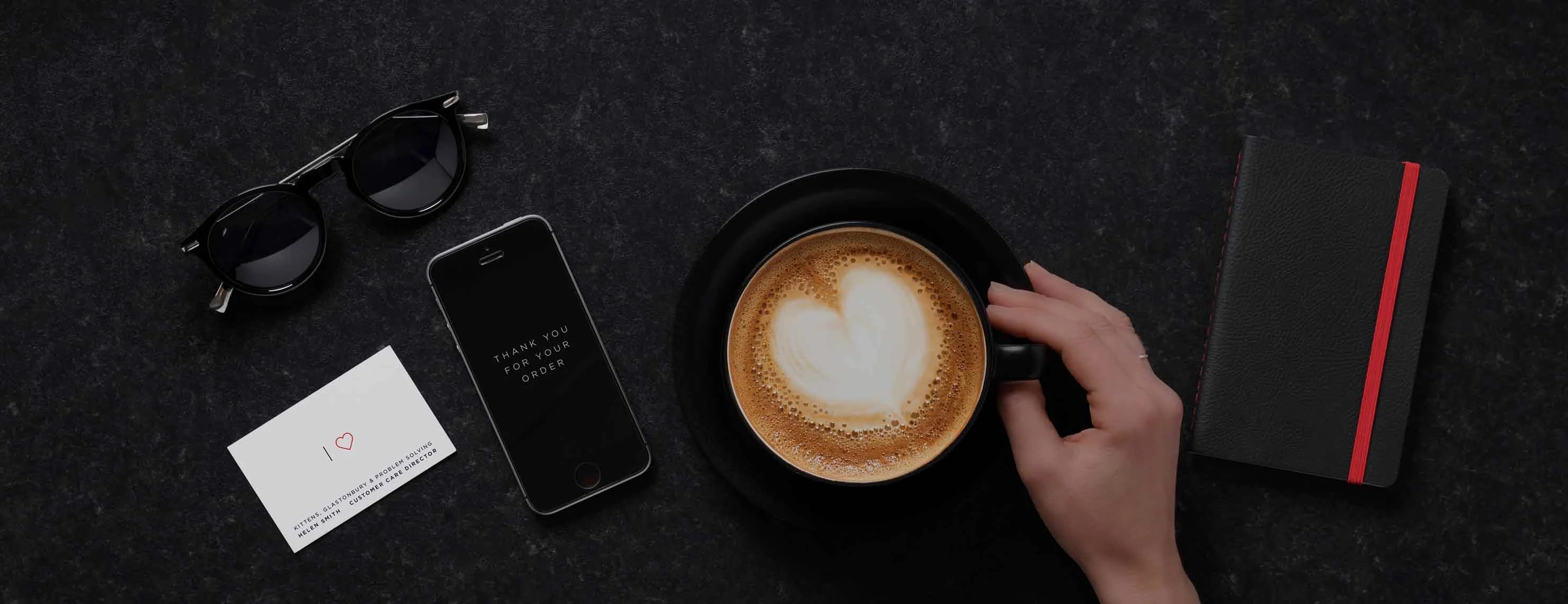 Coffee cup on fresh laundry - Representing ihateironing's premium quality laundry and dry cleaning service with attention to detail